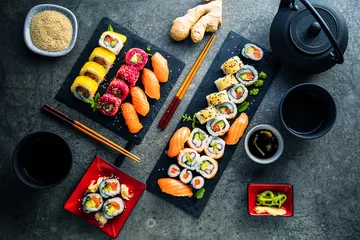  apanese sushi eten. Maki ands rolls met tonijn, zalm, garnalen, krab en avocado. Bovenaanzicht van diverse sushi. Rainbow sushi roll, uramaki, hosomaki en nigiri © karepa