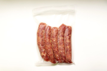 Chinese sausage in vacuum package isolated on white background.