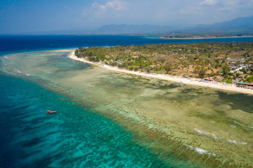 Aerial drone view of a beautiful tropical beach and coral reef on a small island (Gili Air, Indonesia)