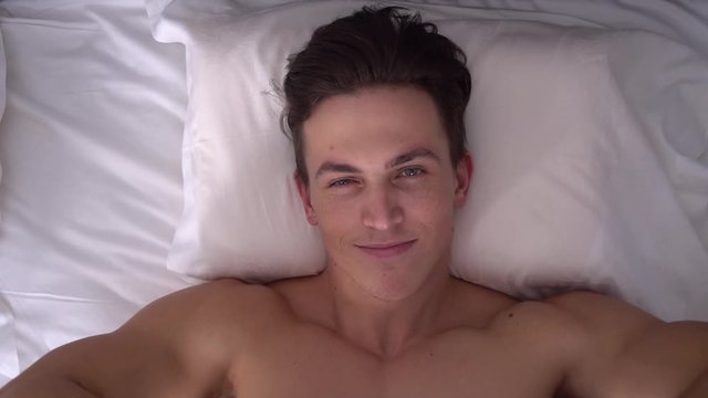 Young man on bed rest in bedroom daily lifestyle concept woke up