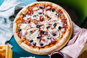 Neapolitan pizza with olives and salami