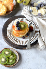 Fritters with honey, banana, blueberries and kiwi, breakfast