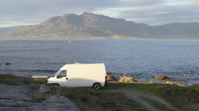 Camper van motorhome view on a sea landscape with mountains living van life in Galiza, Spain