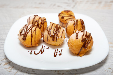 Small donuts with chocolate frosting