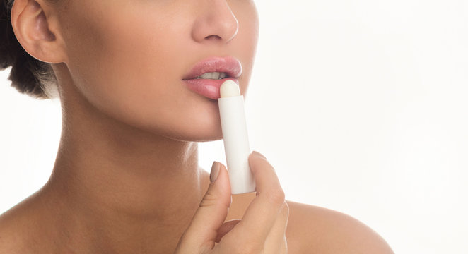 Close Up Of Woman Applying Lip Balm Stick