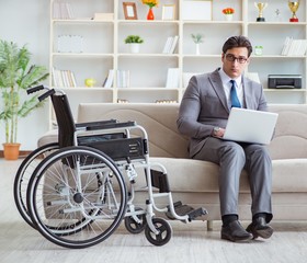 Dsabled businessman on wheelchair working home