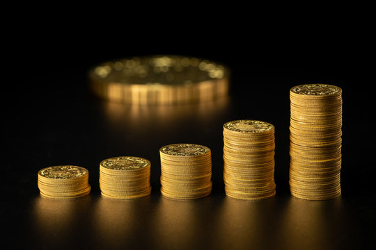 Stacks Of Old Gold Coins In A Row, Big Coin In The Background