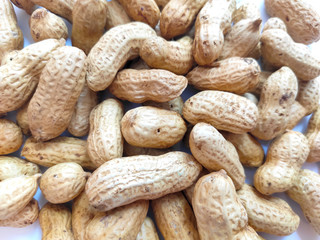Group of Unpeeled peanuts in shell for background.