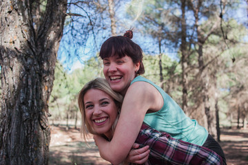 Couple of girls in the field laughing and enjoying