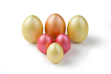 Cute golden and pink metallic Easter eggs isolated on white.