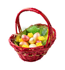 Golden and bronze Easter eggs with flowers and leaves in red basket.