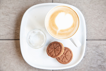 Hot coffee art latte and cookies