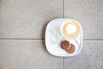 Hot coffee art latte and cookies