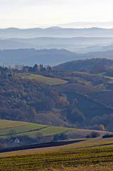 Naklejka premium Distant hills in the haze. Beautiful mountain scenery. Mystical rural scenes. Scattered houses of mountain villages. Beautiful nature background.