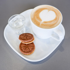 Hot coffee art latte and cookies