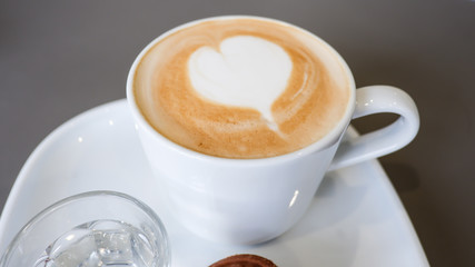 Hot coffee art latte and cookies