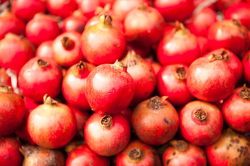 Fresh juicy pomegranates on a counter in the market.
