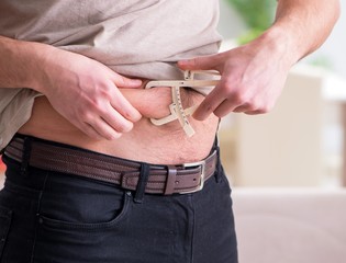 Man measuring body fat with calipers