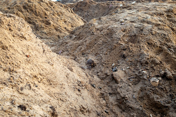 Piles of sand with traces of shoes. Selective focus