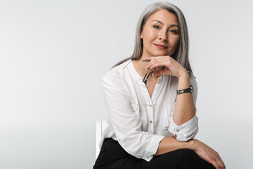 Image of adult mature woman with long gray hair wearing office clothes