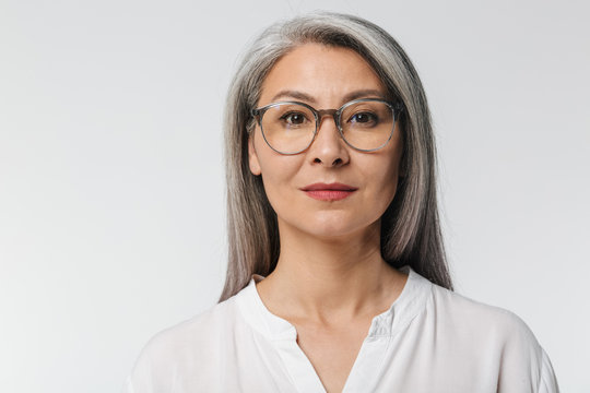 Image of adult mature woman wearing eyeglasses and office clothes