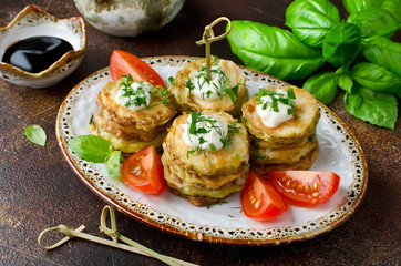 Fried zucchini with sauce, dill, parsley and garlic.