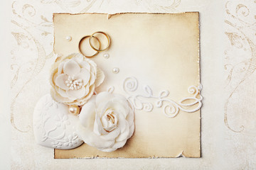 wedding rings, flowers and wedding invitation