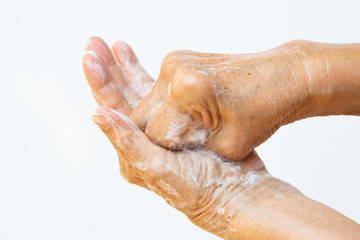 Senior woman's hands washing her hands using soap foam in step 4 on white background, Close up & Macro shot, Selective focus, Prevention from covid19, Bacteria, healthcare concept, 7 step wash hand