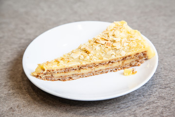 Sliced of almond tart on white plate