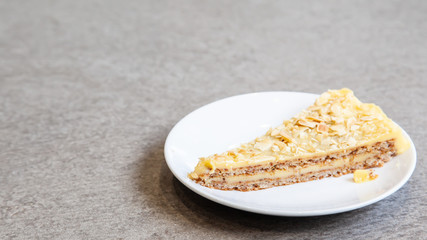 Sliced of almond tart on white plate