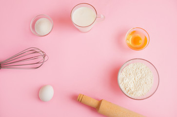 Frame of food ingredients for baking on a gently pink pastel background. Cooking flat lay with copy space. Top view. Baking concept.