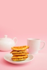 Pancakes with berries on a bright pastel background, copy space.