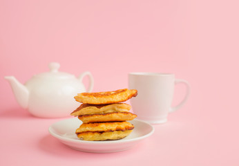 Pancakes with berries on a bright pastel background, copy space.
