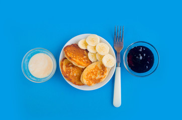 Pancakes with berries on a bright pastel background, copy space.