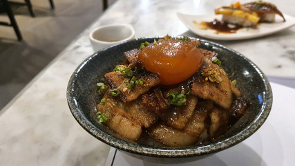 Roasted pork belly sliced with Japanese sauce with Soy sauce raw egg yolk on white rice
