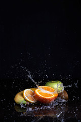 Fruits with water splash on black background