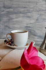 cup with coffee and pink tulip