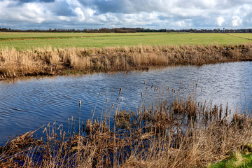 Fototapeta premium Canalas behind the dikes in Sneum near Esbjerg, Denmark