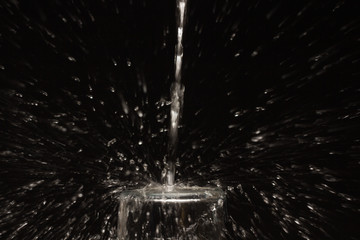 Drinking water falling in a glass