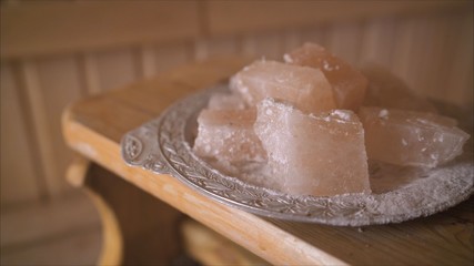 Salt in the sauna. Salt therapy. Salt in a plate in the interior of the sauna.