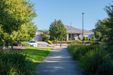 A pedestrian footpath/walkway leads to residential houses in an Australian suburb. Melbourne, VIC...
