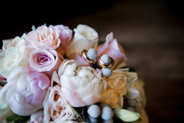 wedding rings near the bride's bouquet