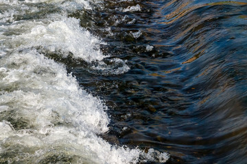 A small flat cascade in a calm river