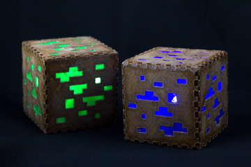 Obraz premium Minecraft cubes made of plastic. Two brown minecraft cubes with glowing Windows
