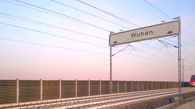 wuhan train station signboard,train travels under railway billboard china