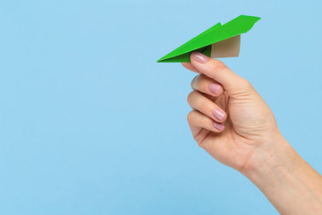 Hands holding the sign of paper airplane or message on blue studio background. Negative space, advertising. Social media, showing meaning, communication, gadgets, modern technologies.