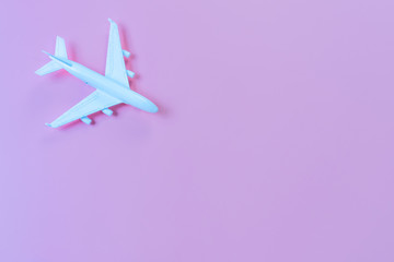 Top view of model plane, airplane on pink color background, travel concept. Flat lay , copy space