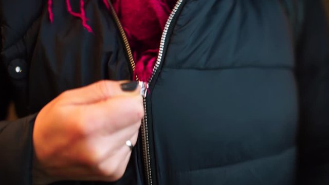 Woman zips up jacket. The lock captures the scarf fabric and freezes. Socialism what the hell.