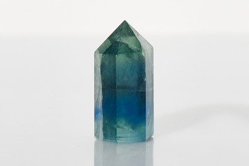 Beautiful faceted natural raw mineral crystal fluorite close-up isolated on white background