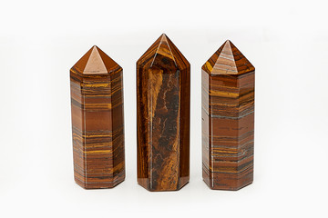 Three beautiful natural raw mineral crystal Tiger's Eye close up isolated on white background